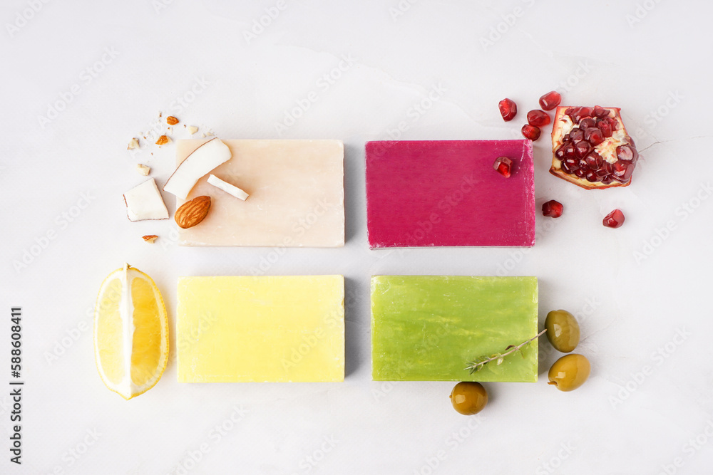 Composition with soap bars and natural ingredients on light background