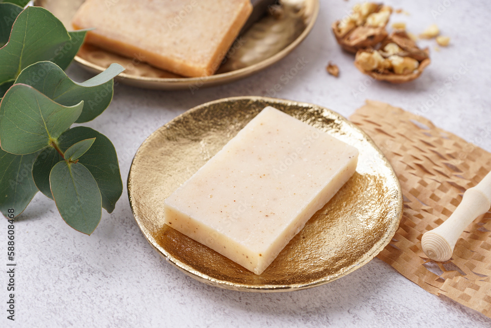 Plate with natural soap bar on light table, closeup