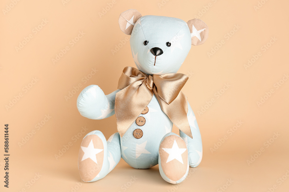 Toy bear on beige background