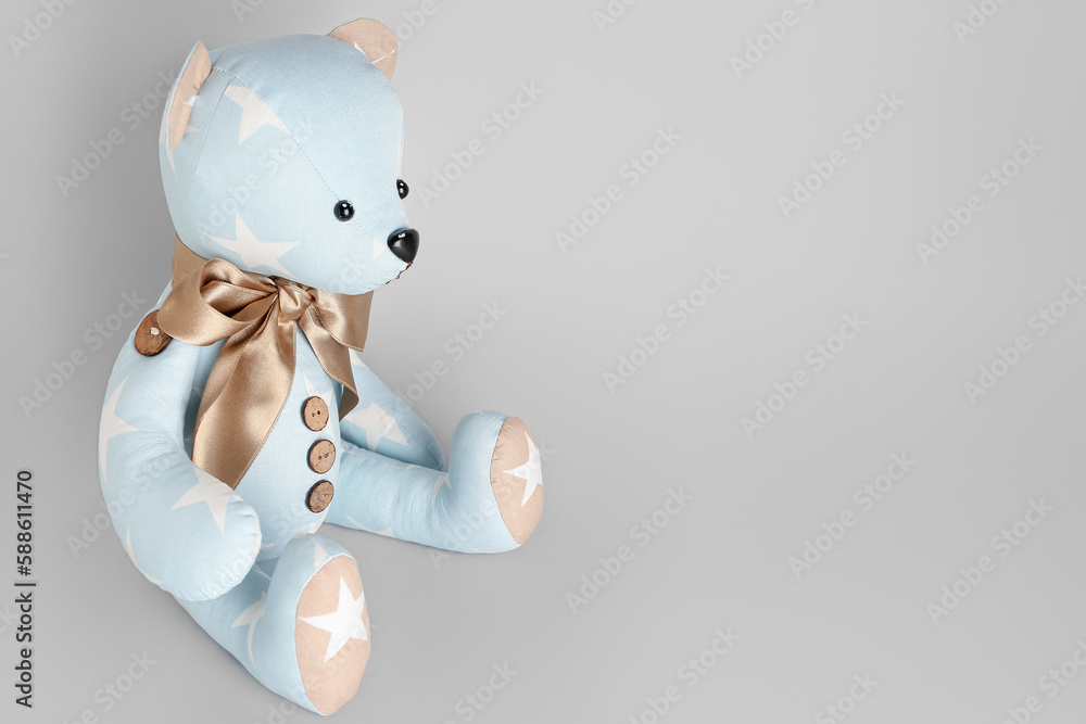 Toy bear on grey background