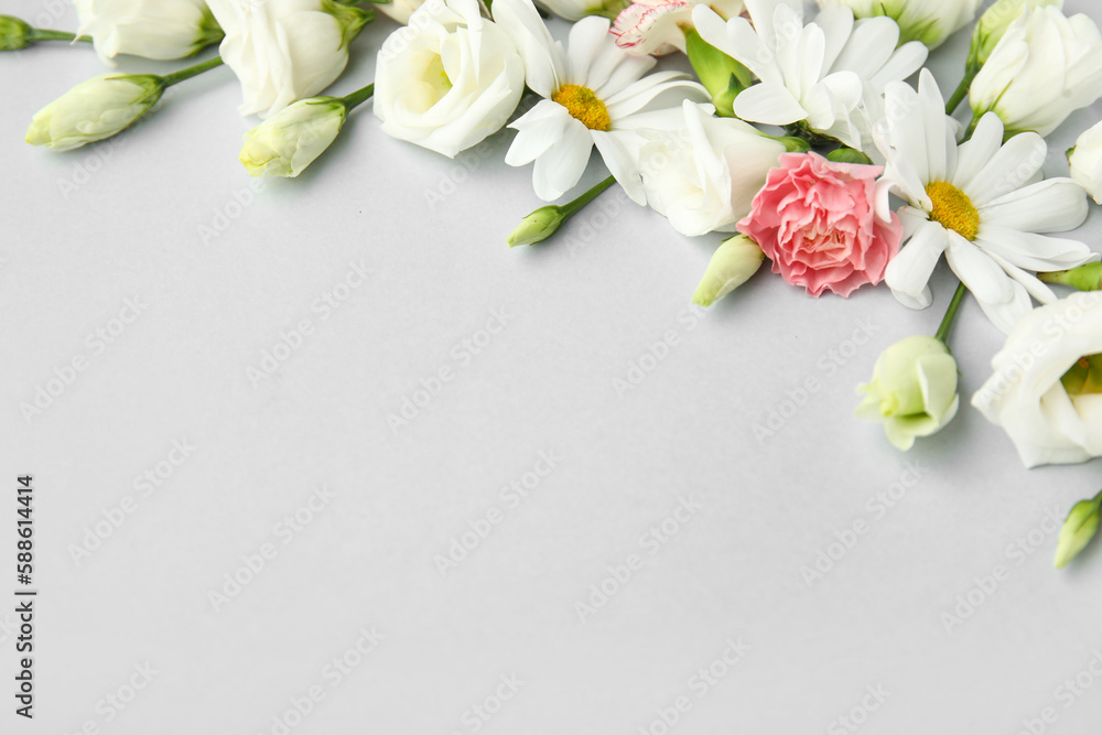 Beautiful composition with delicate flowers on light background