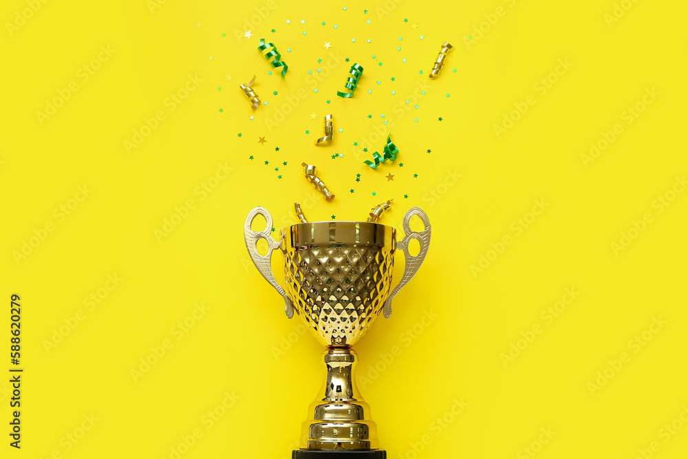 Gold cup with stars and serpentine on yellow background