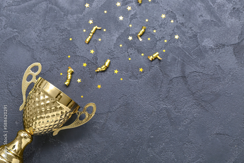 Gold cup with serpentine and stars on dark background