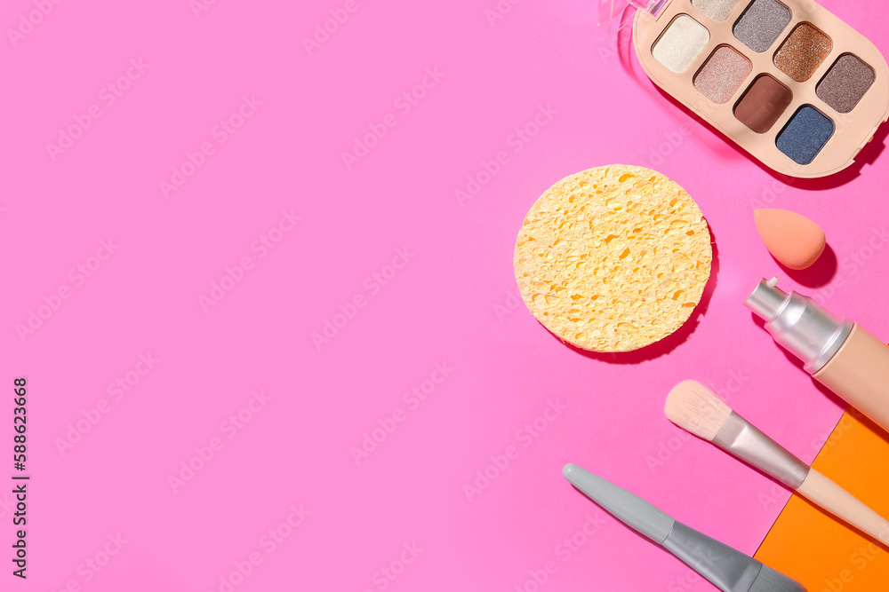 Decorative cosmetics with makeup brushes and sponges on color background