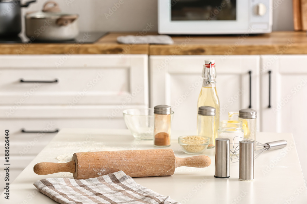 Rolling pin and ingredients for preparing Italian Grissini on table in kitchen