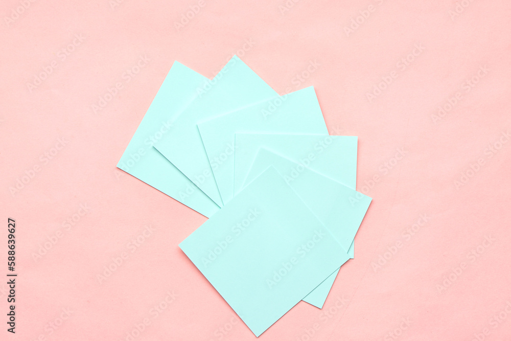 Blue sticky notes on pink background