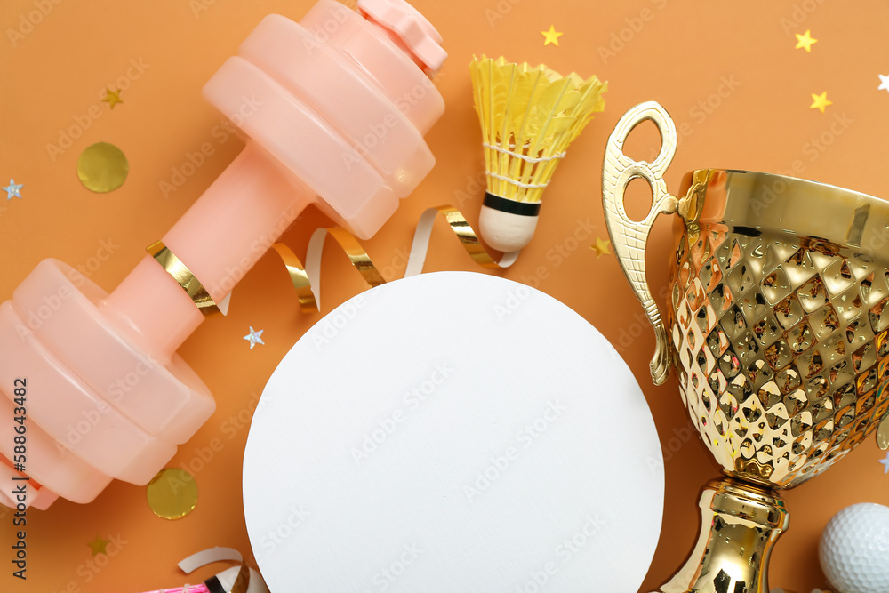 Blank card with gold cup, sports equipment and confetti on orange background