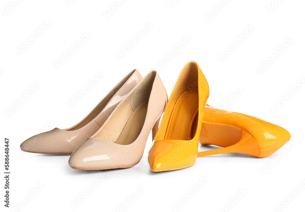 Stylish high heeled shoes on white background