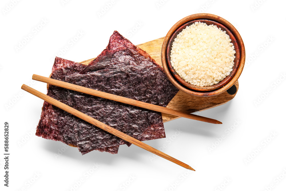 Wooden board with natural nori sheets, chopsticks and bowl of rice isolated on white background