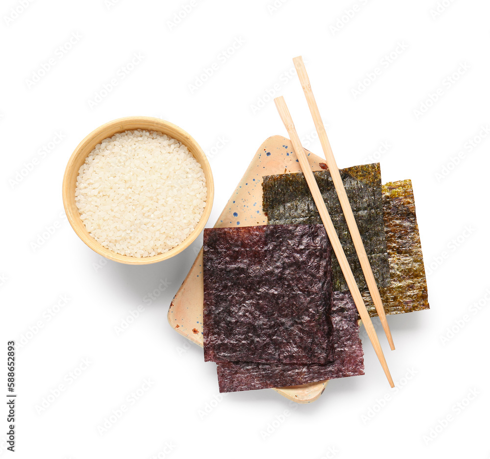 Plate with natural nori sheets, chopsticks and bowl of rice isolated on white background