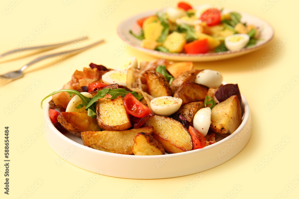 Plate of tasty potato salad with eggs, tomatoes and bacon on beige background