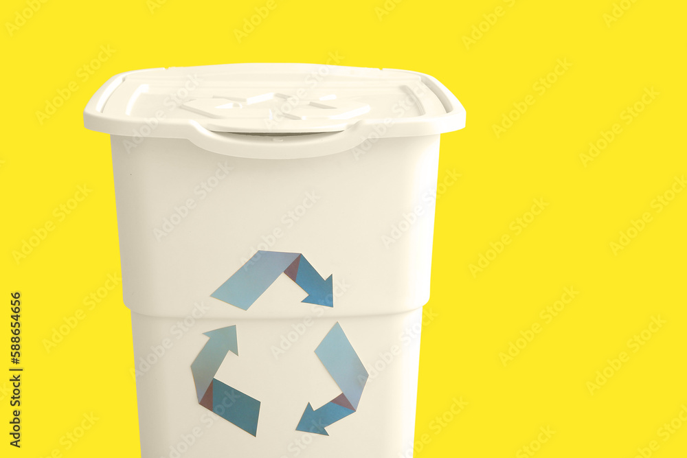 Container for garbage on yellow background. Recycling concept