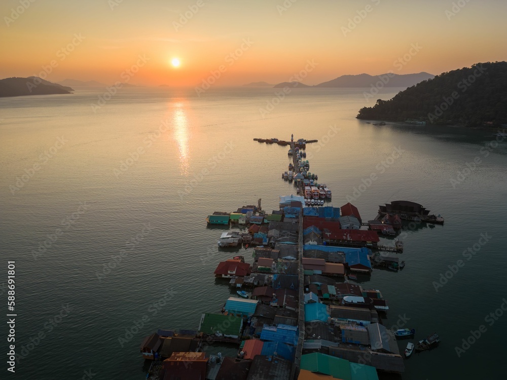 Bang Bao floating fishing village on Koh Chang Thailand with the golden sunset in the background