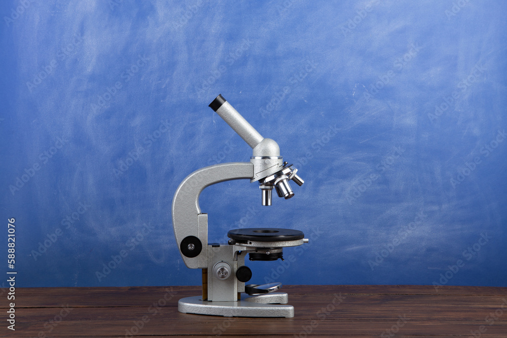 Back to school - microscope on the desk, Education concept. Blackboard background