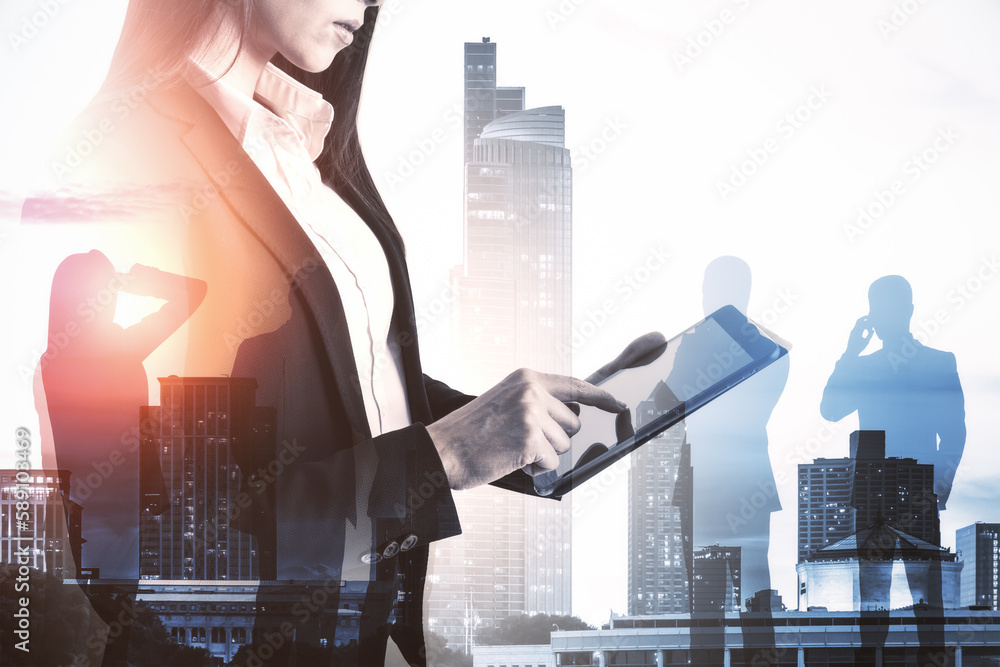 Headless young businesswoman using tablet on abstract bright city background with crowd. Success, wo