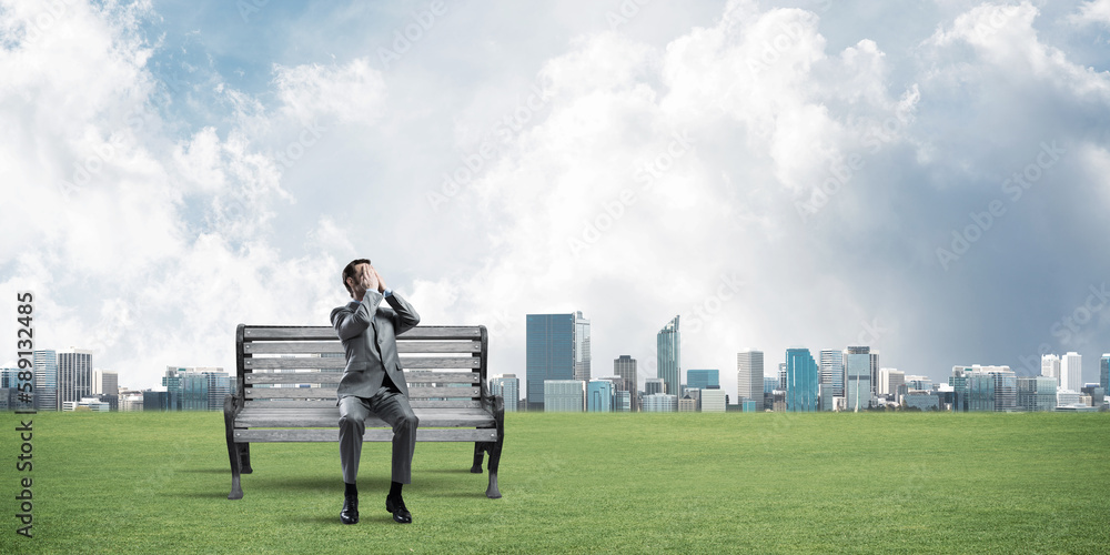 Young man in summer park do not want to see anything