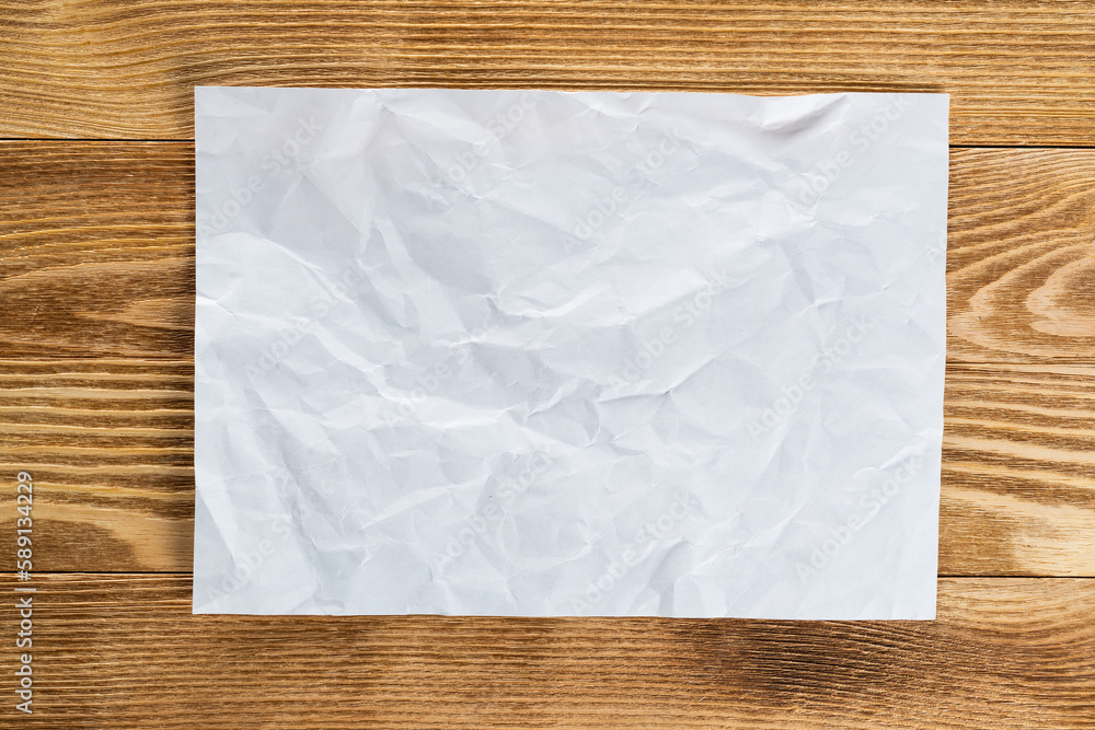 Sheet of paper lying on wooden table