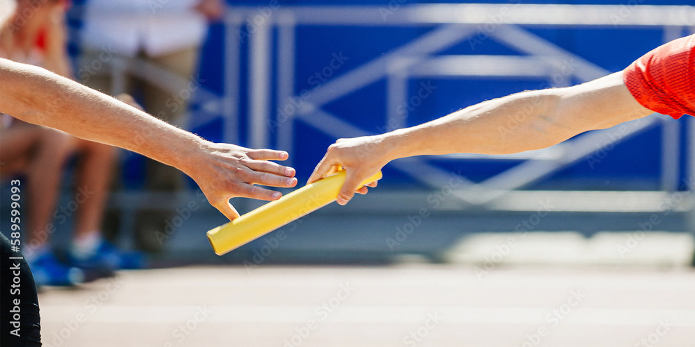 hand men passing baton running relay race in summer athletics championship