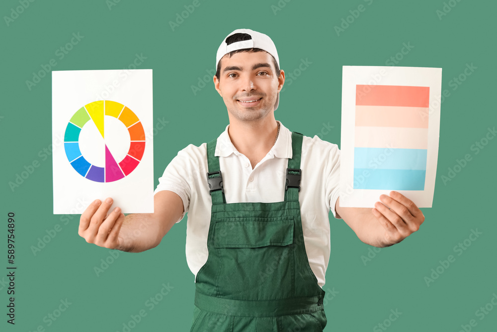 Male painter with color palettes on green background