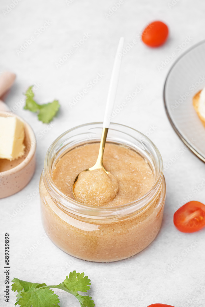 Jar with delicious caviar of capelin on grey background