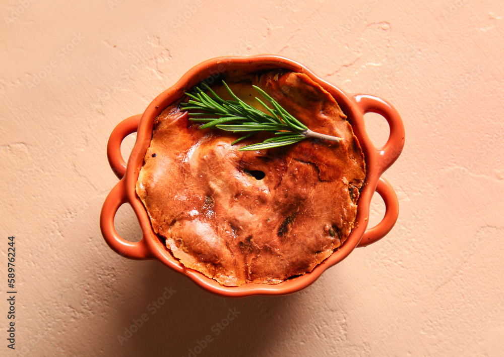 Delicious meat pie in baking form on beige table