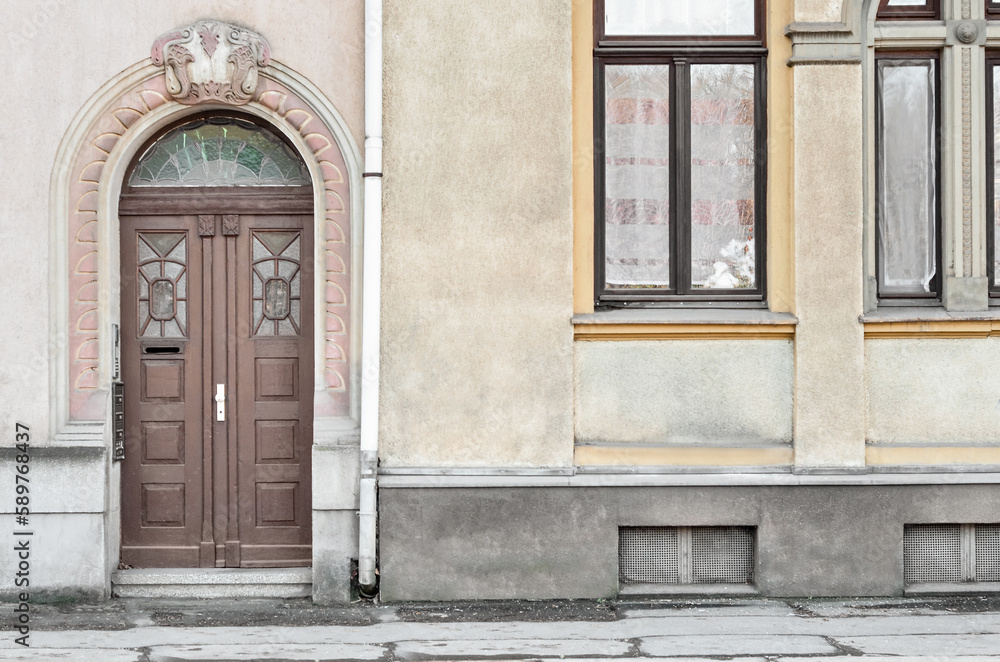 View of old building with wooden door and windows