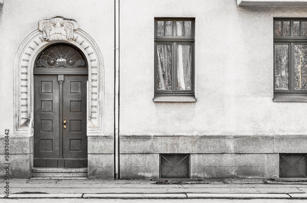 View of old building with wooden door and windows