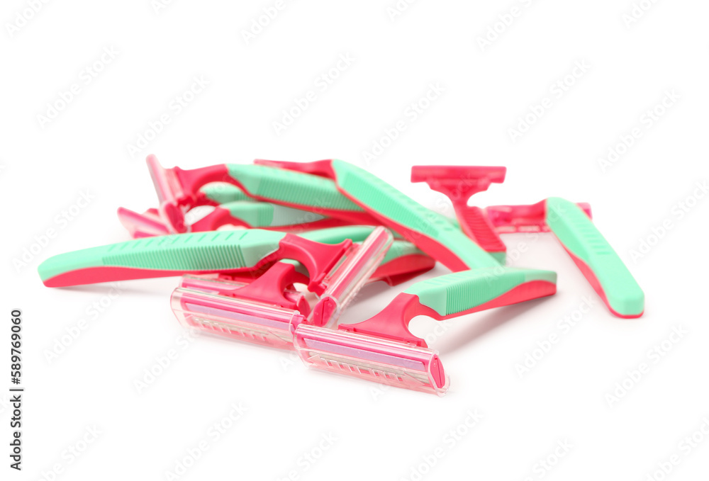 Heap of colorful safety razors on white background