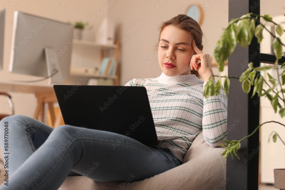 Female programmer working with laptop in office