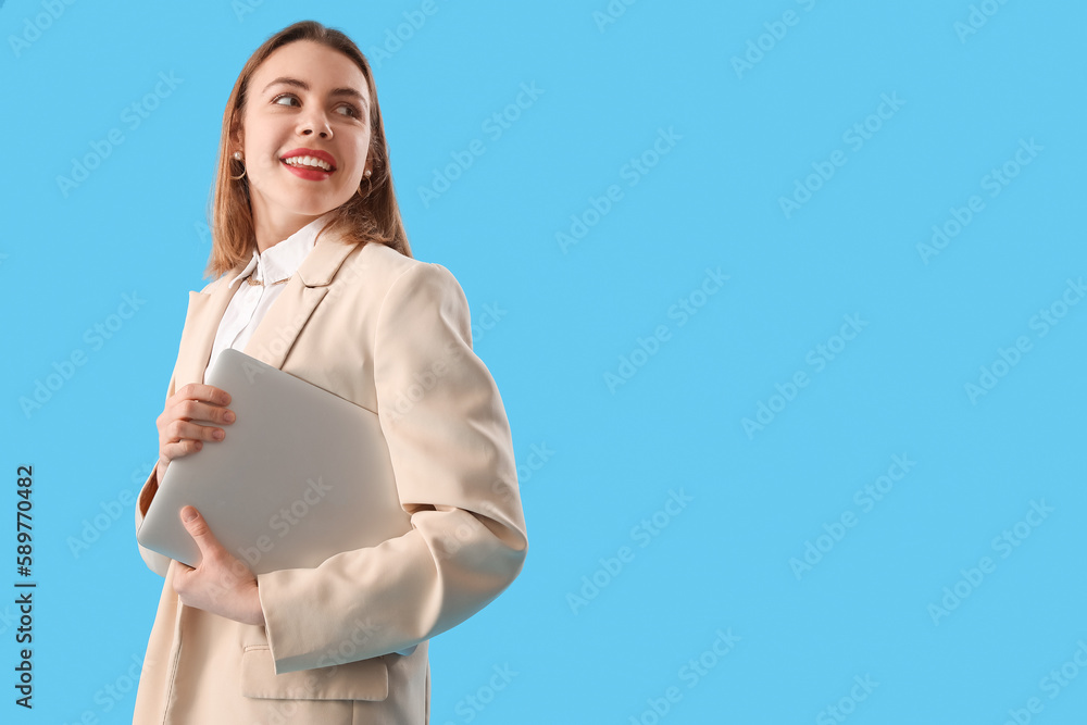 Female programmer with laptop on blue background