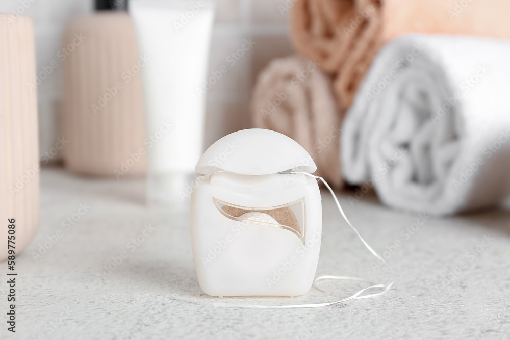 Dental floss on table in bathroom, closeup