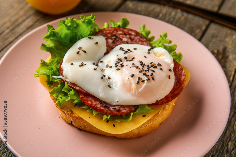 Plate with tasty egg Benedict on wooden background, closeup