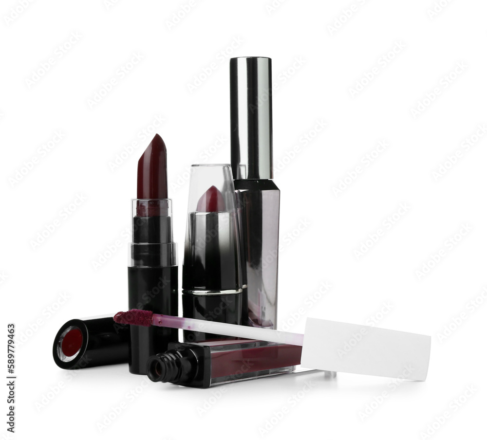 Lipsticks with mascara on white background