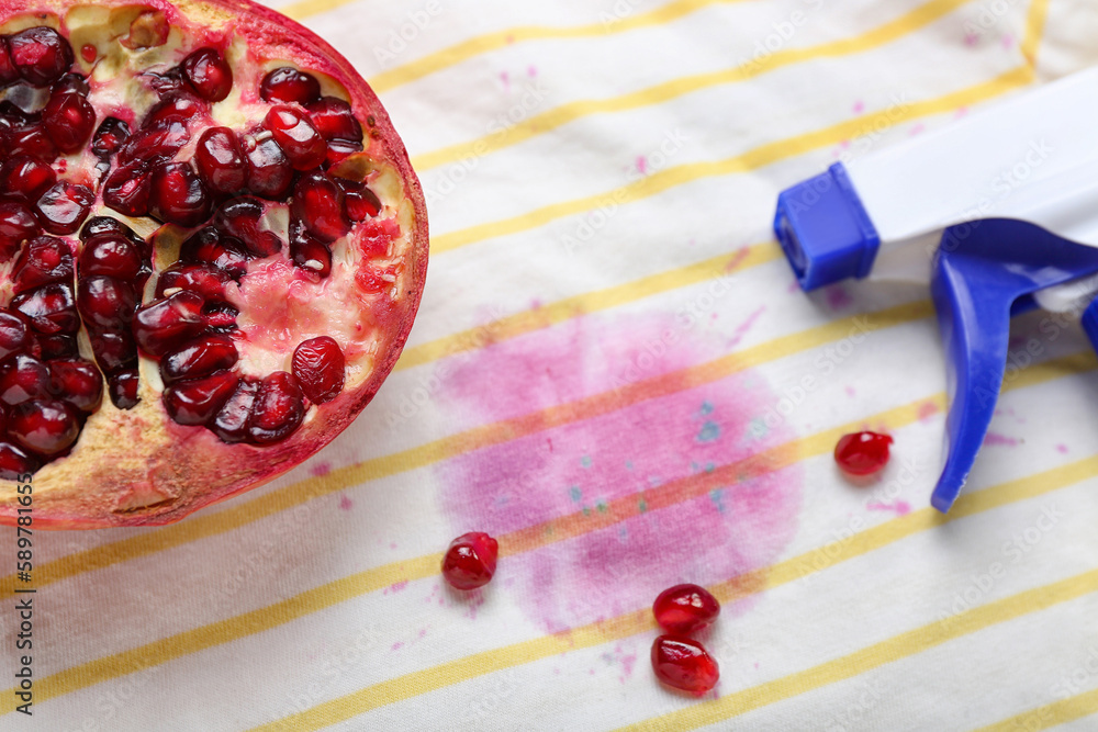 Laundry detergent with pomegranate on stained clothes, closeup