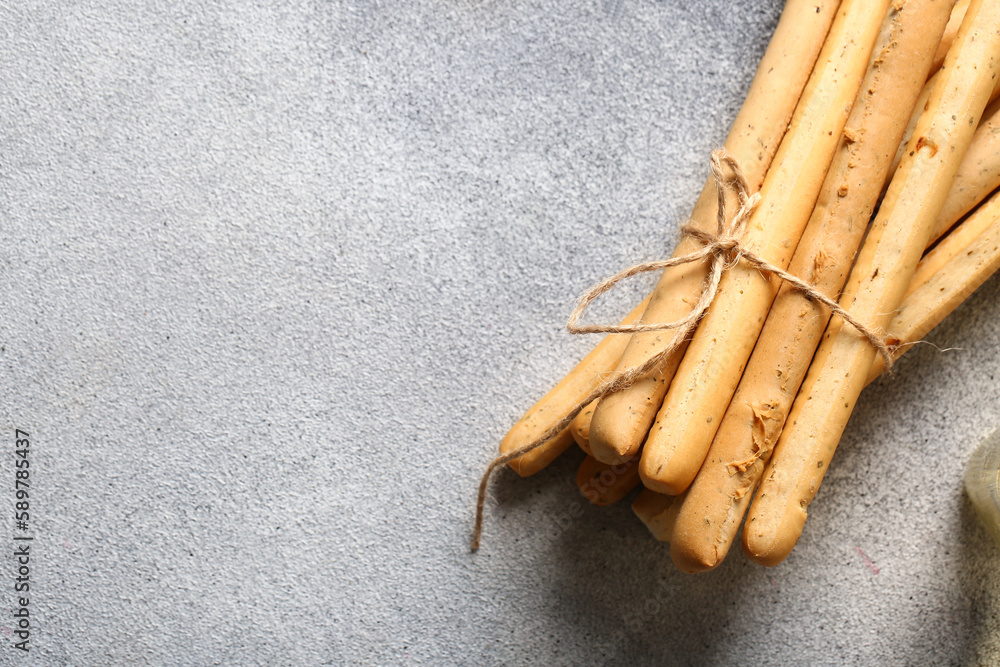 Bunch of tasty Italian Grissini on light background