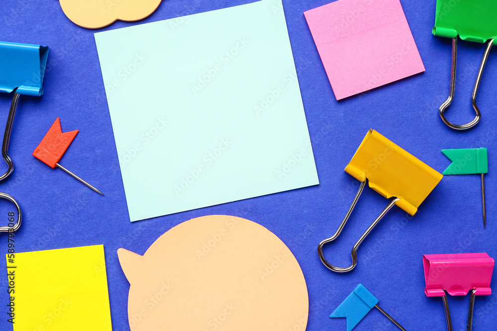 Colorful sticky notes and stationery on blue background