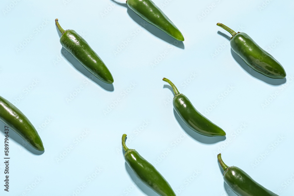 Composition with green pepper on blue background