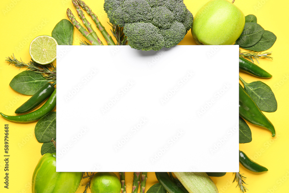 Composition with different fresh vegetables, fruits and blank paper sheet on yellow background