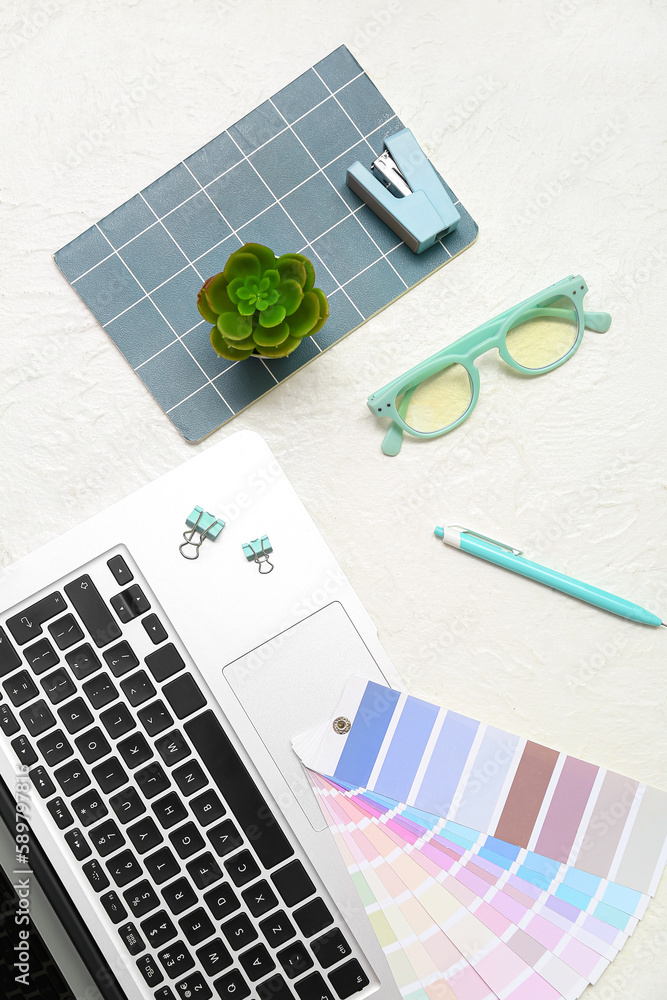 Composition with laptop, eyeglasses, notepad and plant on white background