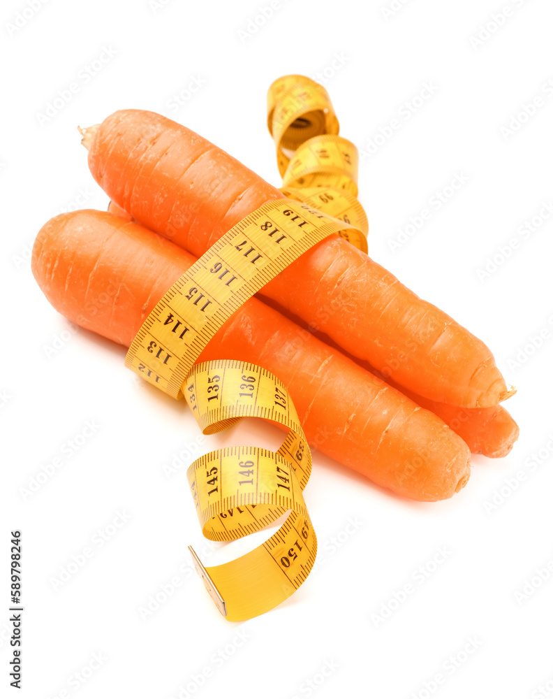 Carrots and yellow measuring tape on white background. Diet concept