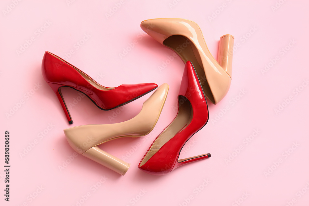 Fashionable high heeled shoes on pink background