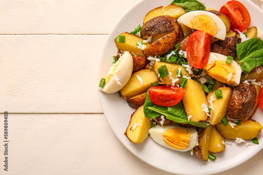 Plate of tasty potato salad with eggs and tomatoes on light wooden background, top view