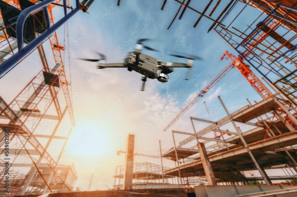 Drone over construction site. video surveillance or industrial inspection..