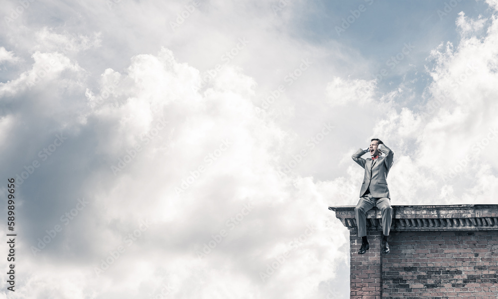 Young man on building roof dont want to hear anything