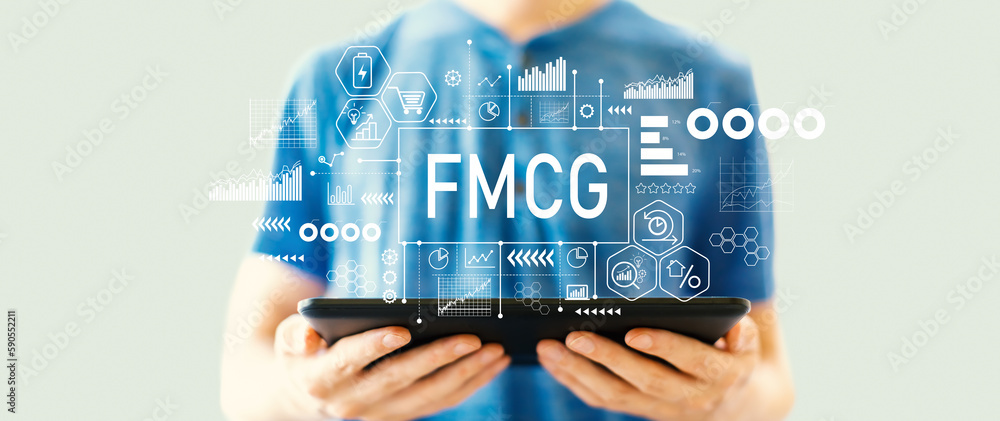 FMCG - Fast Moving Consumer Goods theme with young man using a tablet computer