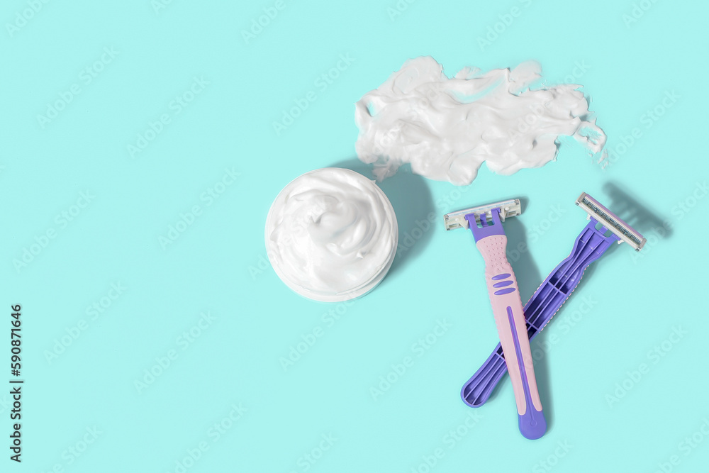 Safety razors and shaving foam on color background