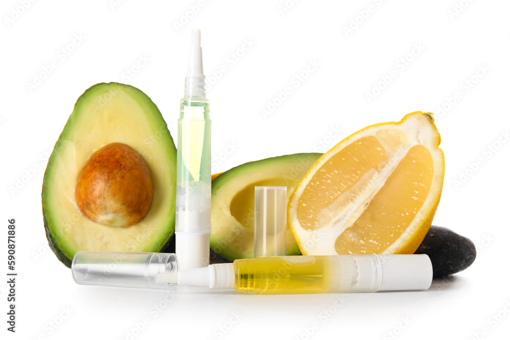 Cuticle oil pens and avocado on white background