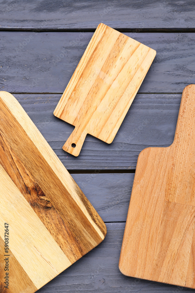 Set of cutting boards on color wooden background, closeup