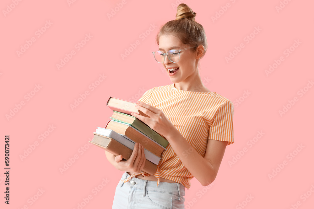 Young woman with books on pink background