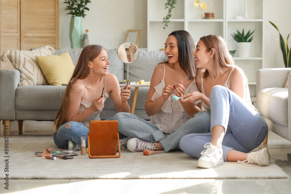 Young women doing makeup at home